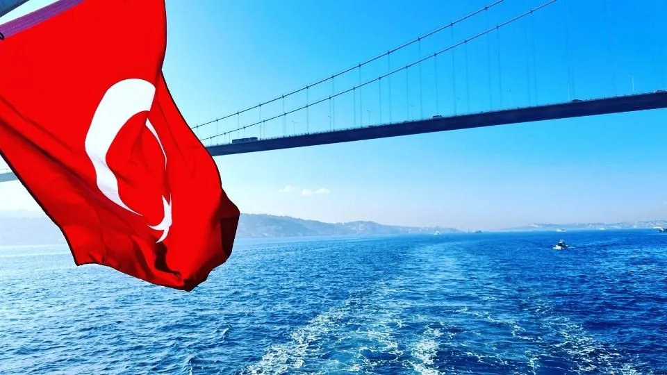 Turkish flag flying in front of the Bosphorus Bridge in Istanbul, the gateway into the country